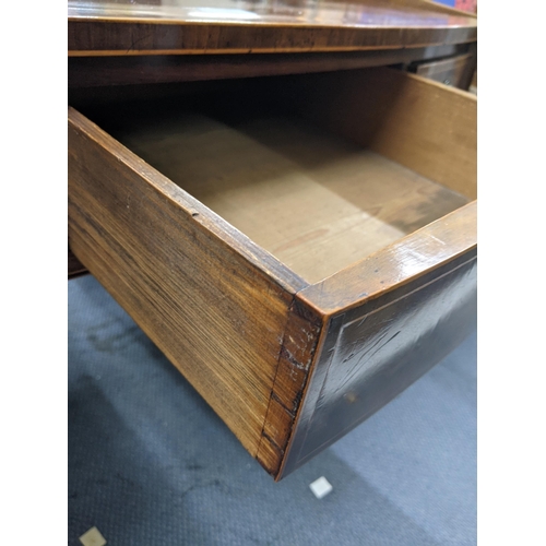 331 - An early 20th century mahogany three-drawer desk with ring handles raised on tapered legs Location: ... 