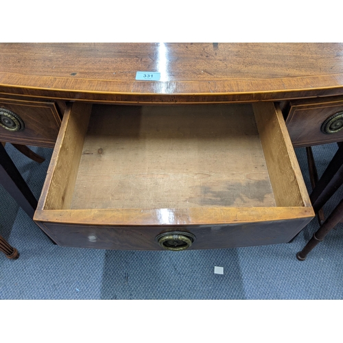 331 - An early 20th century mahogany three-drawer desk with ring handles raised on tapered legs Location: ... 