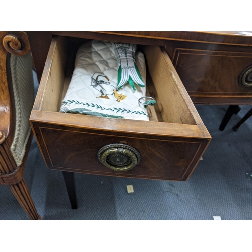 331 - An early 20th century mahogany three-drawer desk with ring handles raised on tapered legs Location: ... 