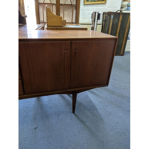 345 - An Everest teak sideboard with cupboards at both ends and three central drawers, raised on turned le... 