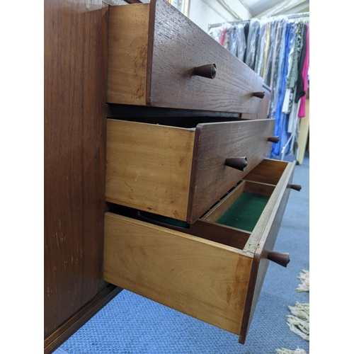 345 - An Everest teak sideboard with cupboards at both ends and three central drawers, raised on turned le... 