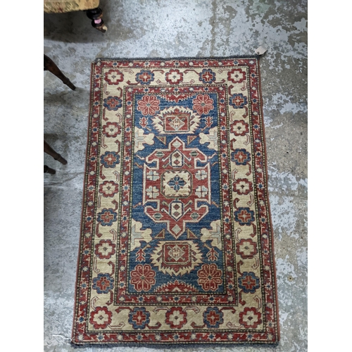 499 - A Kozak Caucasian rug with geometric motifs and a blue ground, 137cm x 88cm
Location: RAB
If there i... 