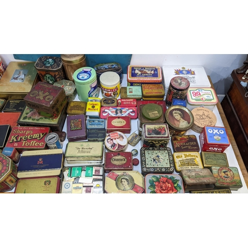 264 - A large collection of vintage branded tins to include Players cigarettes, Oxo, Marmite, Harrods and ... 