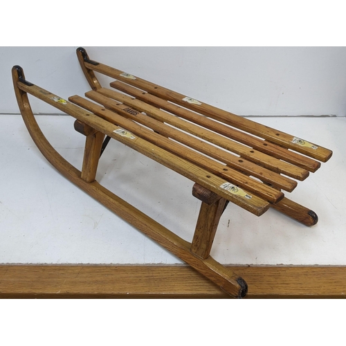 265 - A vintage Austrian sledge measuring 91cm x 29cm
Location: SR
If there is no condition report, please... 