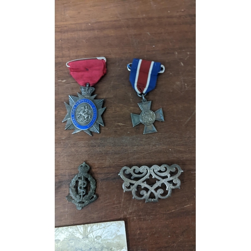 306 - A group of military medals to include Royal Army temperance medals and badges together with an accom... 