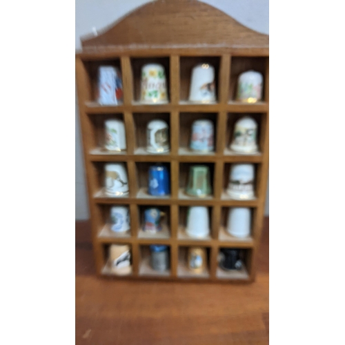 323 - A collection of thimbles to include a Chelsea porcelain example, a Wedgwood example, a P&D Weston ex... 