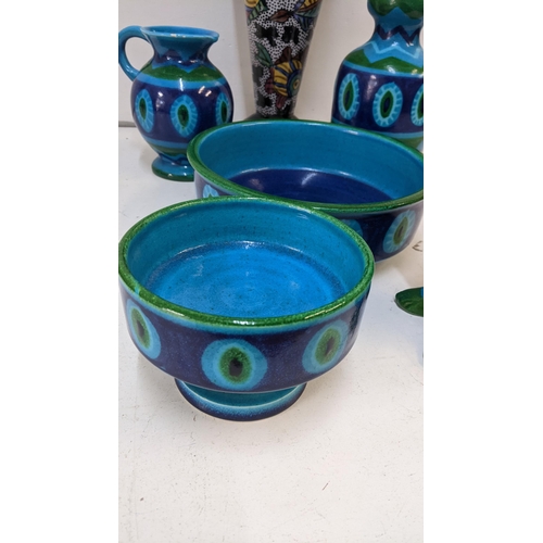 401 - A set of mid 20th century turquoise and green glazed pottery to include a jug, a vase, two bowls, an... 