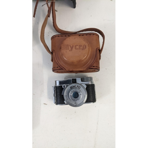 42 - A group of vintage cameras to include a Mycro camera with original box and leather case, a Kadak, a ... 