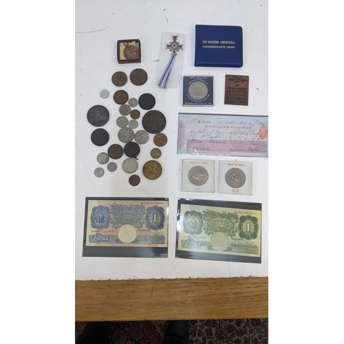 43 - A collection of coins and collectable items to include a cartwheel penny dated 1797, a coin from the... 