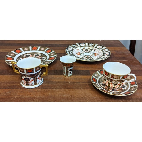 492 - Royal Crown Derby Imari pattern china to include cup and saucer, two plates and a twin handled mug, ... 