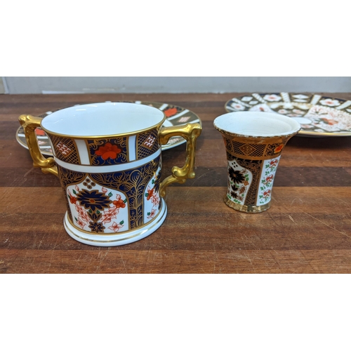 492 - Royal Crown Derby Imari pattern china to include cup and saucer, two plates and a twin handled mug, ... 