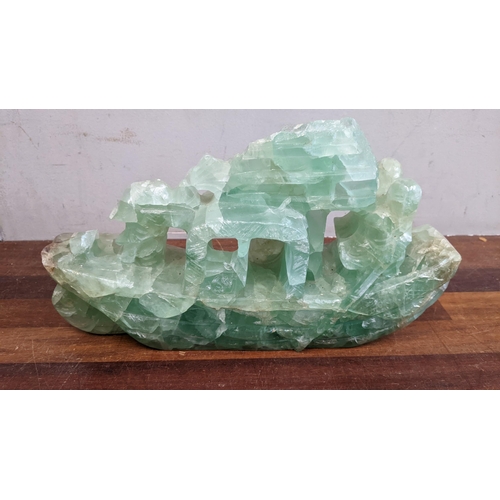 493 - A jade coloured carved stone junk, a mother of pearl and stone model plant and model fish Location: ... 