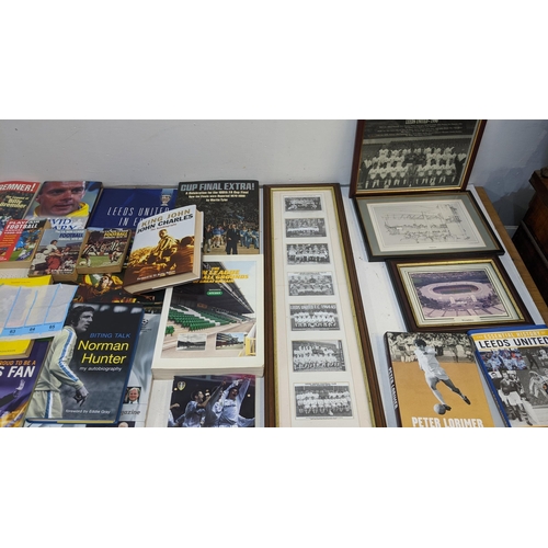 63 - A collection of sporting related items to include Leeds United related books and framed pictures and... 