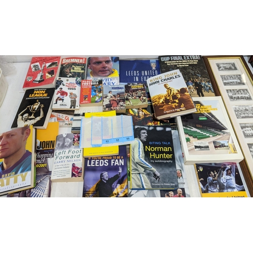 63 - A collection of sporting related items to include Leeds United related books and framed pictures and... 