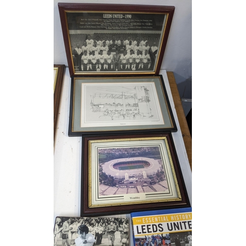 63 - A collection of sporting related items to include Leeds United related books and framed pictures and... 