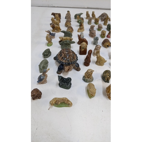 64 - A  large collection of Wade porcelain miniatures to include tortoises, Hedgehogs, cats and others
Lo... 