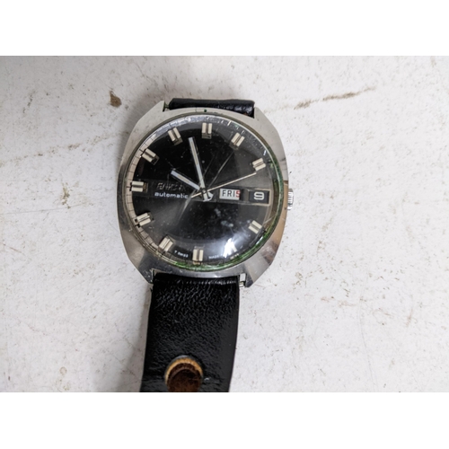 141 - An Enicar automatic gents wristwatch on a black leather strap, the black face with date aperture at ... 