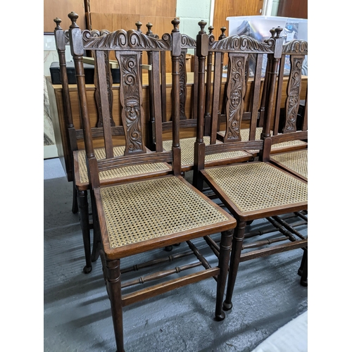 154 - A set of six late 19th century Continental oak framed dining chairs with carved ornament and cane se... 