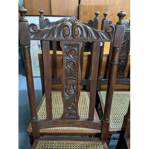 154 - A set of six late 19th century Continental oak framed dining chairs with carved ornament and cane se... 