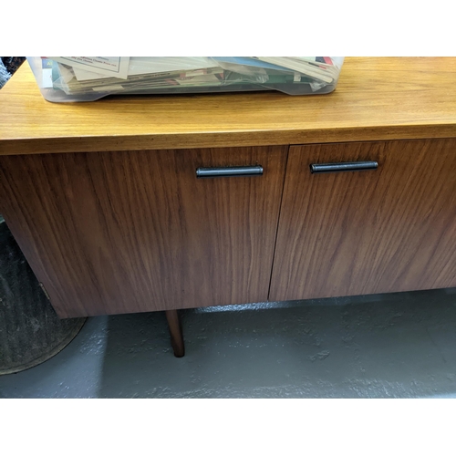 157 - A mid-century retro Uniflex teak sideboard with leather clad handles, cutlery drawer above two furth... 