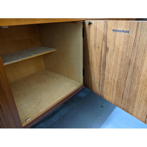 157 - A mid-century retro Uniflex teak sideboard with leather clad handles, cutlery drawer above two furth... 