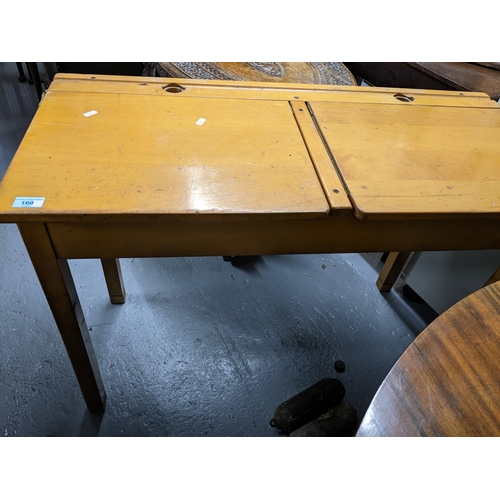 160 - An E Savian child's double school desk, two hinged lids, each with space for an inkwell, on square l... 