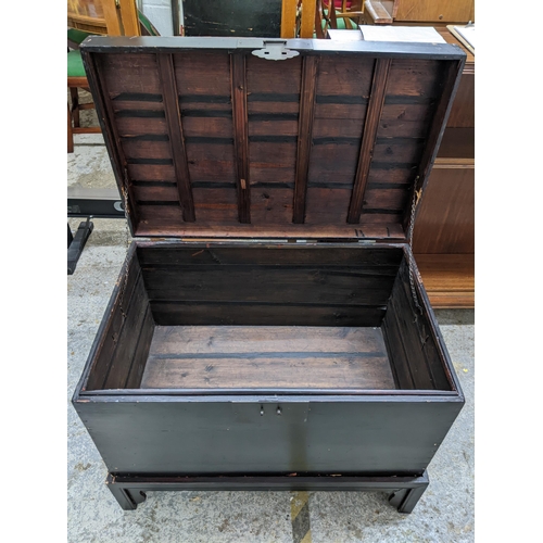 74 - An early to mid 20th century Asian ebonized chest on stand with side carrying handles, 62