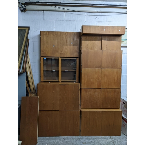 75 - A Danish teak mid century modular wall unit system, comprising various two door cupboards and open s... 