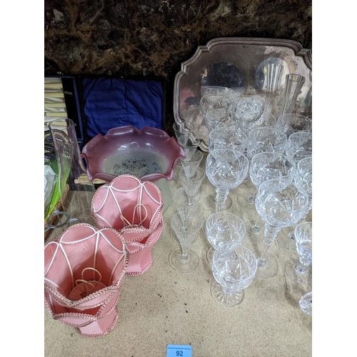 92 - A selection of cut table glass, silver plate, and other items to include a plated tray, and cased cu... 