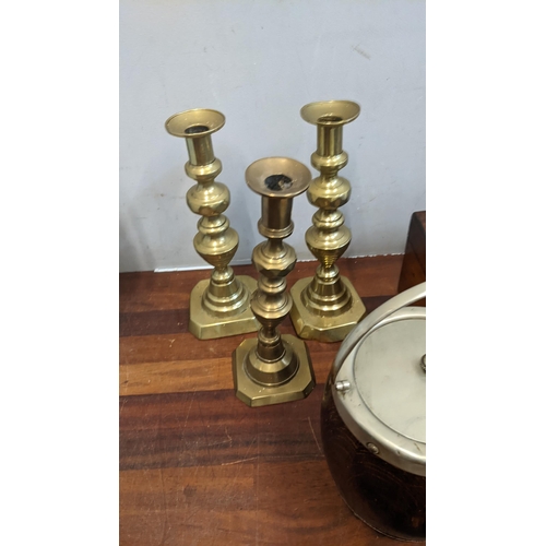 312 - A mixed lot to include three boxes of assorted chess pieces, three brass candlesticks, tea barrels, ... 