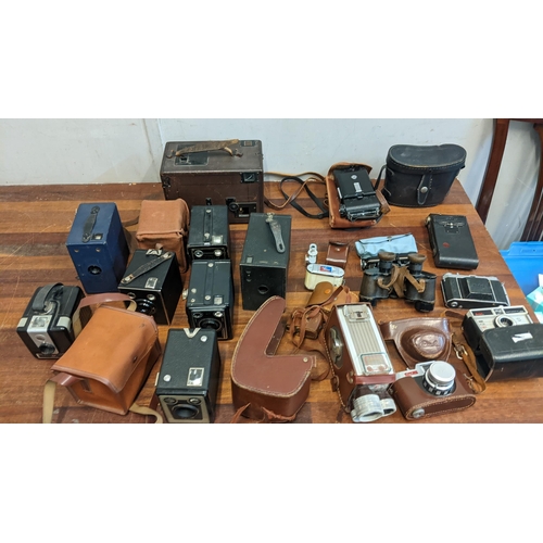 313 - A collection of cameras, photographic equipment and binoculars to include Box Brownies, a Kodak Inst... 