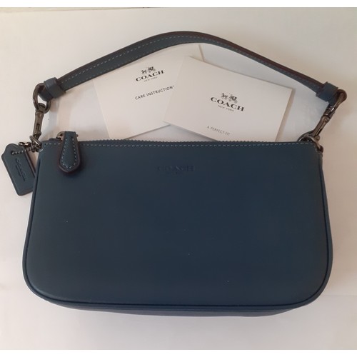 8 - Coach-A small 'Nolita' wristlet bag with detachable strap designed to hold small electronics in smoo... 