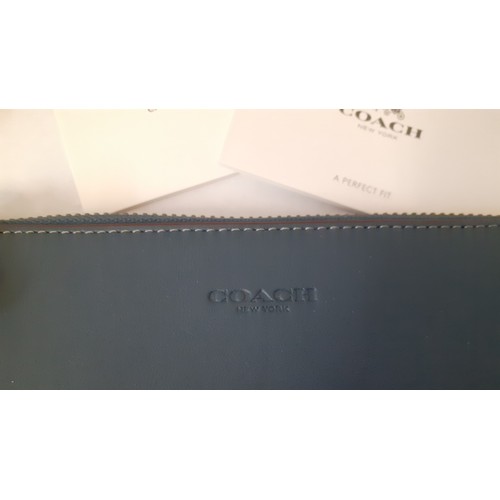 8 - Coach-A small 'Nolita' wristlet bag with detachable strap designed to hold small electronics in smoo... 