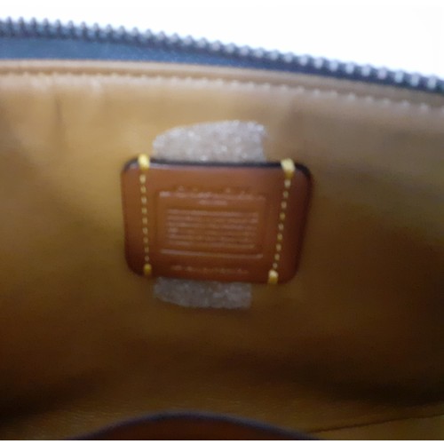 8 - Coach-A small 'Nolita' wristlet bag with detachable strap designed to hold small electronics in smoo... 