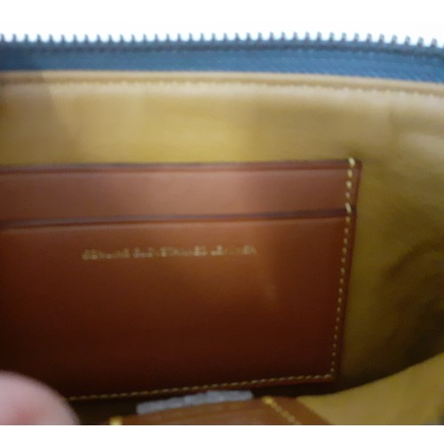 8 - Coach-A small 'Nolita' wristlet bag with detachable strap designed to hold small electronics in smoo... 