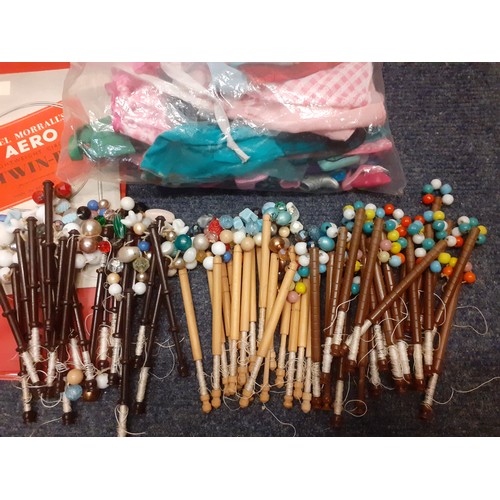 111 - A quantity of light wooden and plastic lace bobbins decorated with beads together with vintage sewin... 