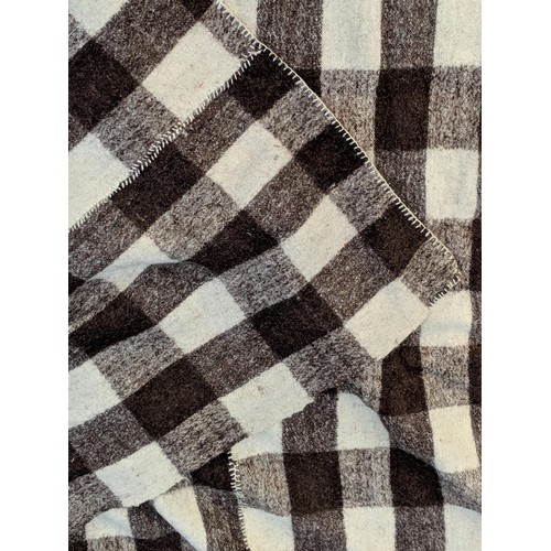 139 - A native American blanket, a vintage brown and white check blanket, a small Chinese mat, a Kelim mat... 