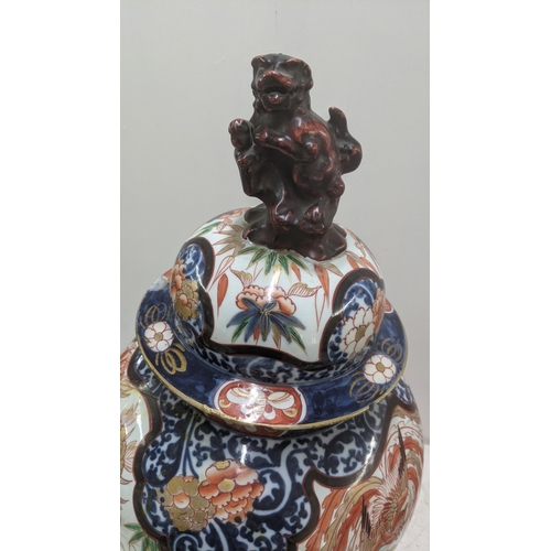 382 - A 19th century Japanese Imari covered vase on wooden stand with lion dog finial A/F
Location: LAM
If... 