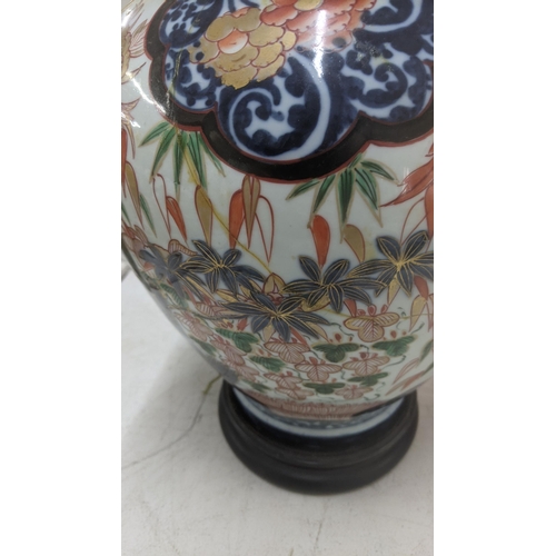 382 - A 19th century Japanese Imari covered vase on wooden stand with lion dog finial A/F
Location: LAM
If... 