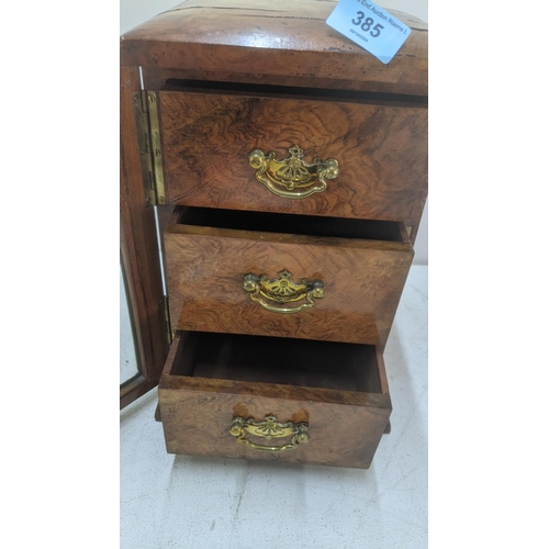 385 - A Victorian walnut collector's chest with three drawers and a door inset with a Gothic glass panel w... 