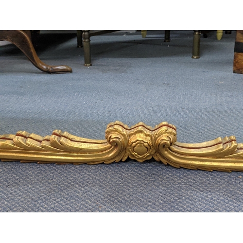 468 - A gilt framed overmantel mirror decorated with gold coloured gilding with a central emblem at the to... 