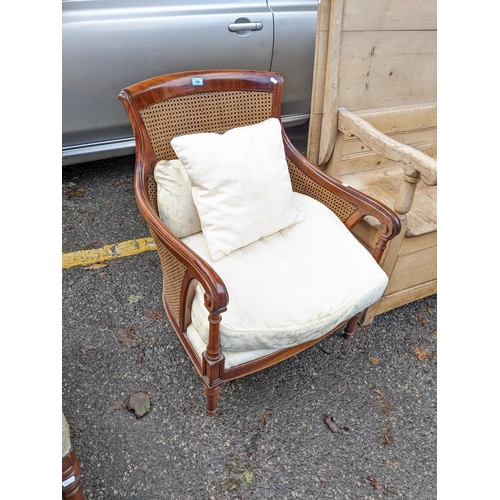 506 - A reproduction of a Regency mahogany bergère chair, with cushions on turned legs
Location: A1B
If th... 