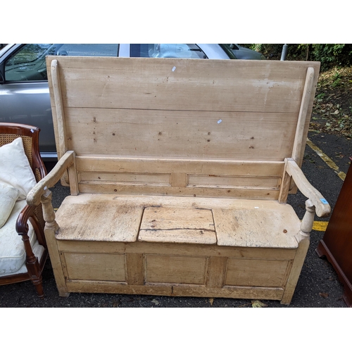 507 - A 19th century pine monks bench with a panelled back and box seat, top down 78cm h x 152cm w
Locatio... 