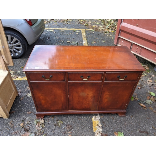 508 - A mahogany cabinet with a hinged top over three doors, 77cm h x 115cm w
Location: RED CON
If there i... 