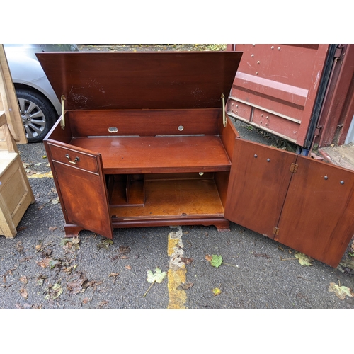 508 - A mahogany cabinet with a hinged top over three doors, 77cm h x 115cm w
Location: RED CON
If there i... 