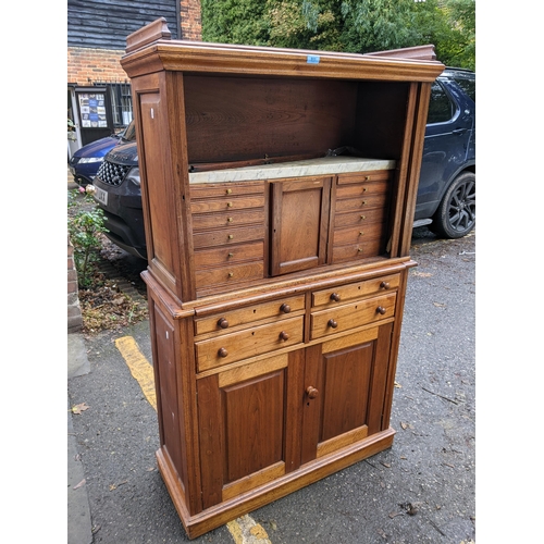 511 - A 19th century hardwood collectors cabinet with a galleried top, over a tambour front, enclosing a m... 