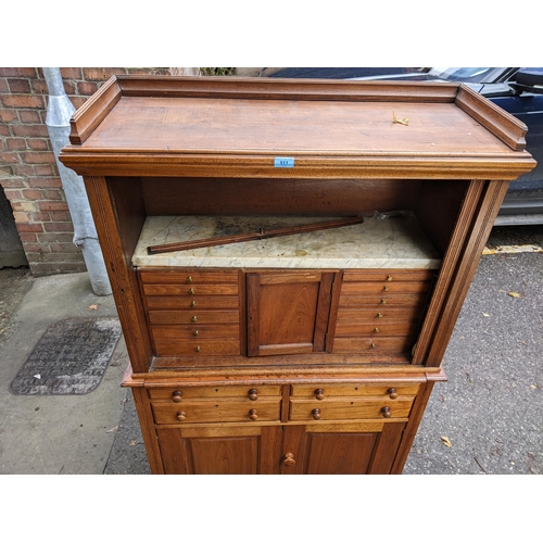 511 - A 19th century hardwood collectors cabinet with a galleried top, over a tambour front, enclosing a m... 