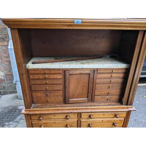 511 - A 19th century hardwood collectors cabinet with a galleried top, over a tambour front, enclosing a m... 