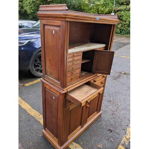 511 - A 19th century hardwood collectors cabinet with a galleried top, over a tambour front, enclosing a m... 