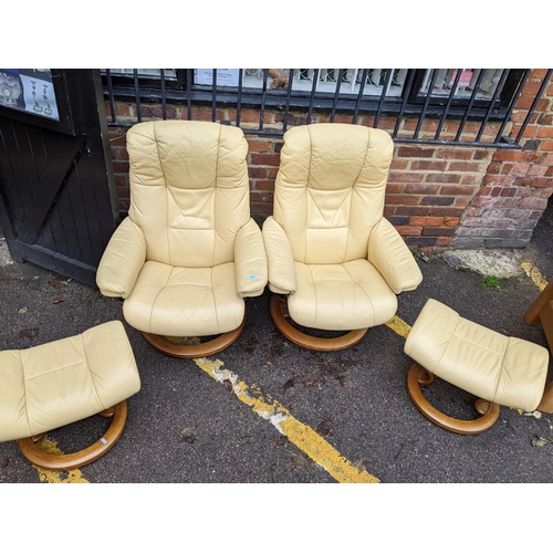 524 - A pair of Stressless cream/yellow leather upholstered reclining armchairs with matching stools Locat... 